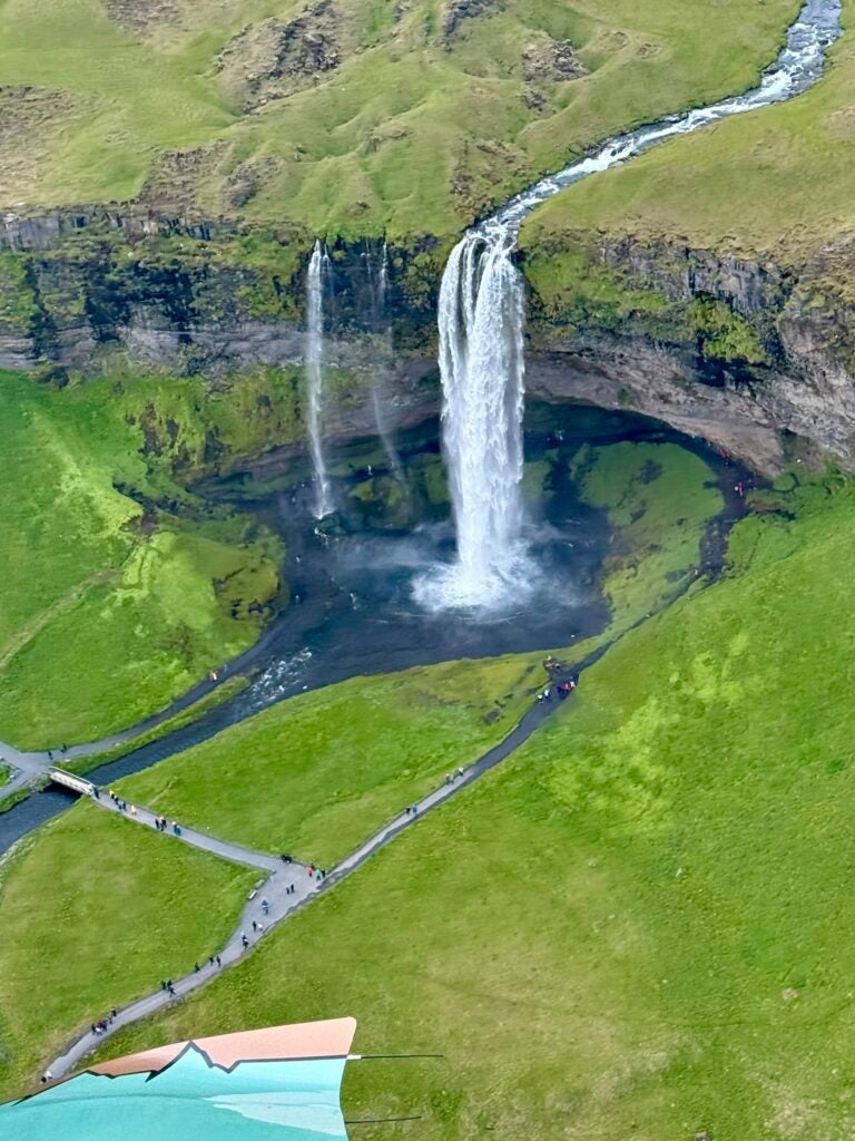 flying over iceland waterfall