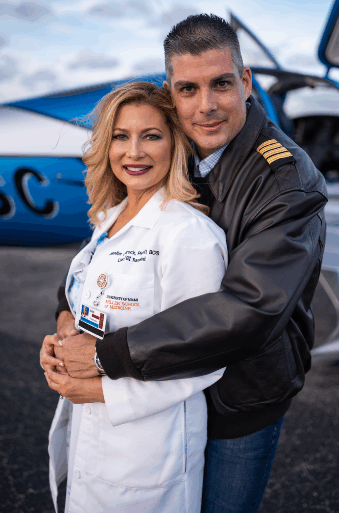 couple in front of SR Series plane