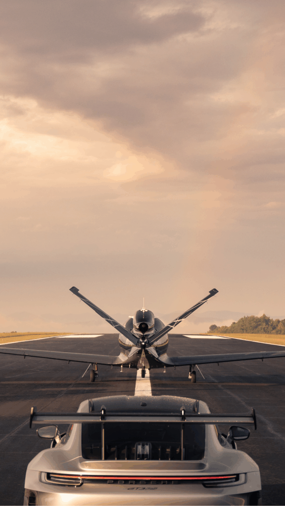 vision jet and Porsche on a runway
