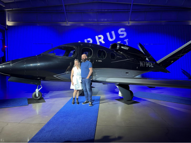 couple in front of vision jet plane