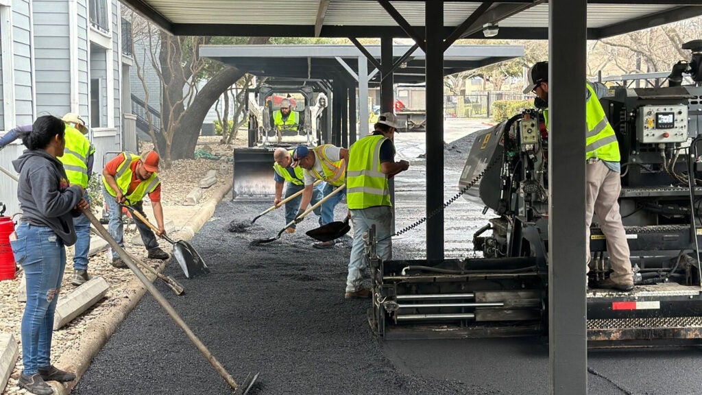 construction workings paving a parking lot