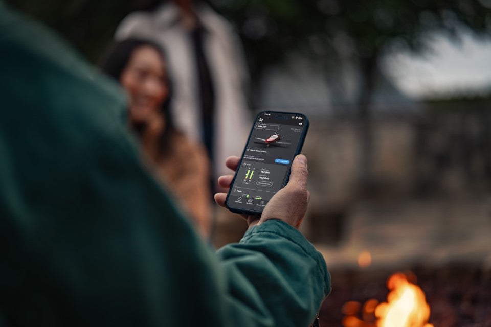 person holding cellphone with IQ app open