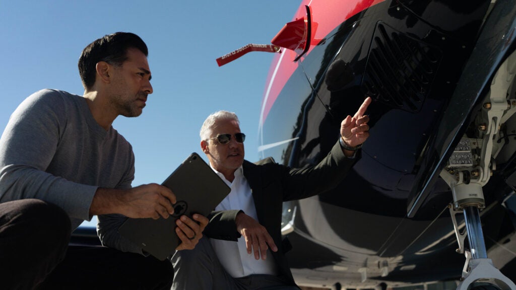 2 men pre flighting a vision jet