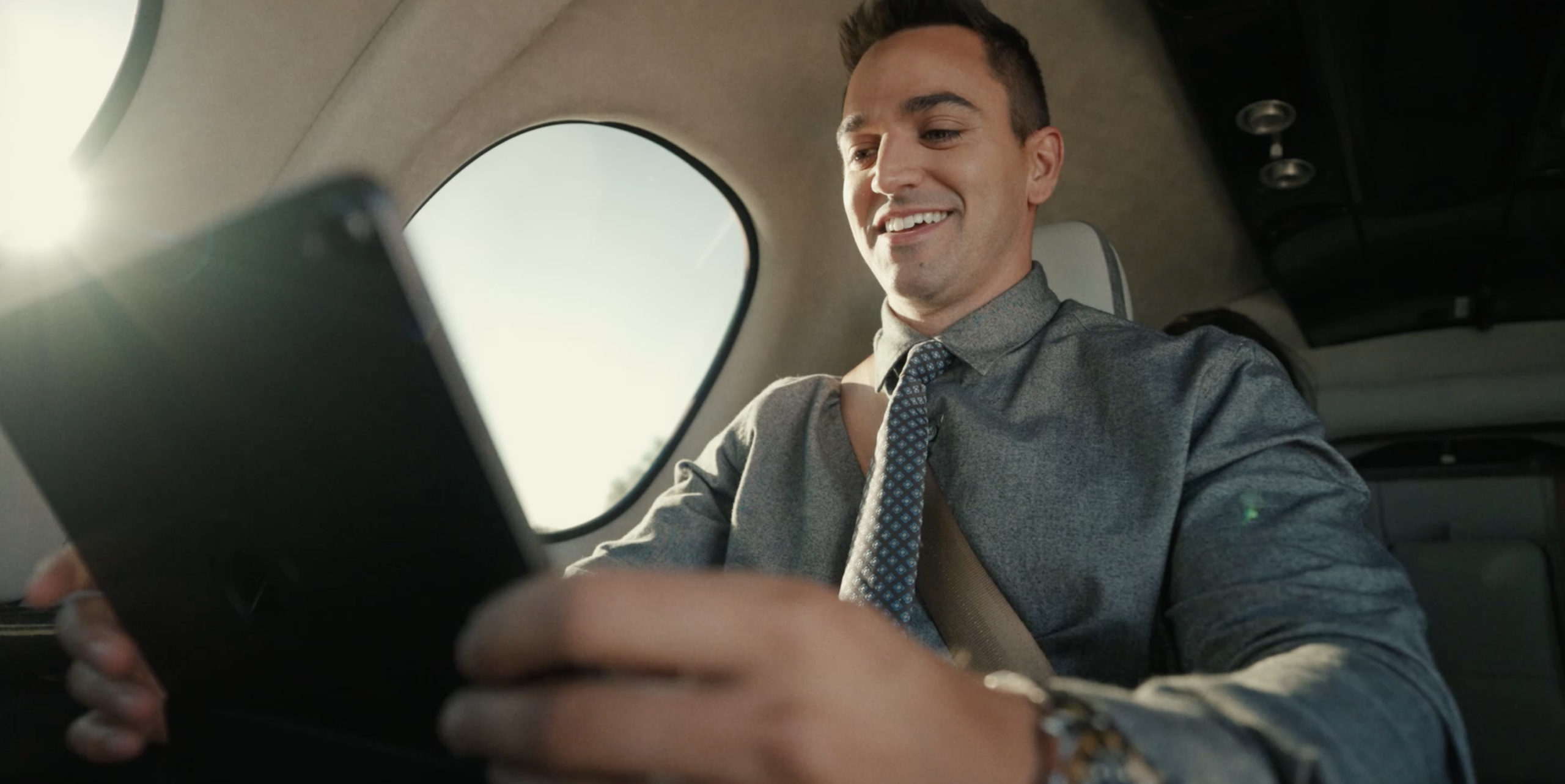 man sitting in vision jet looking at iPad