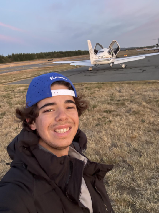Student taking a selfie in front of cirrus SR series 