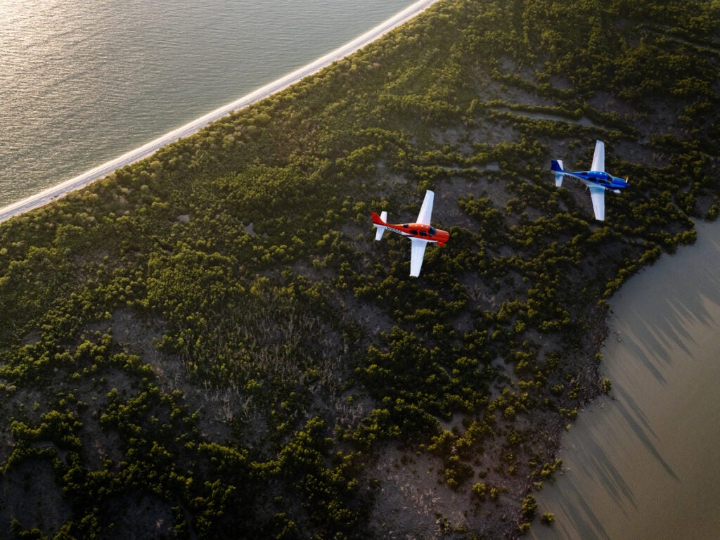 air to air shot of two sr series aircrafts flying over coast