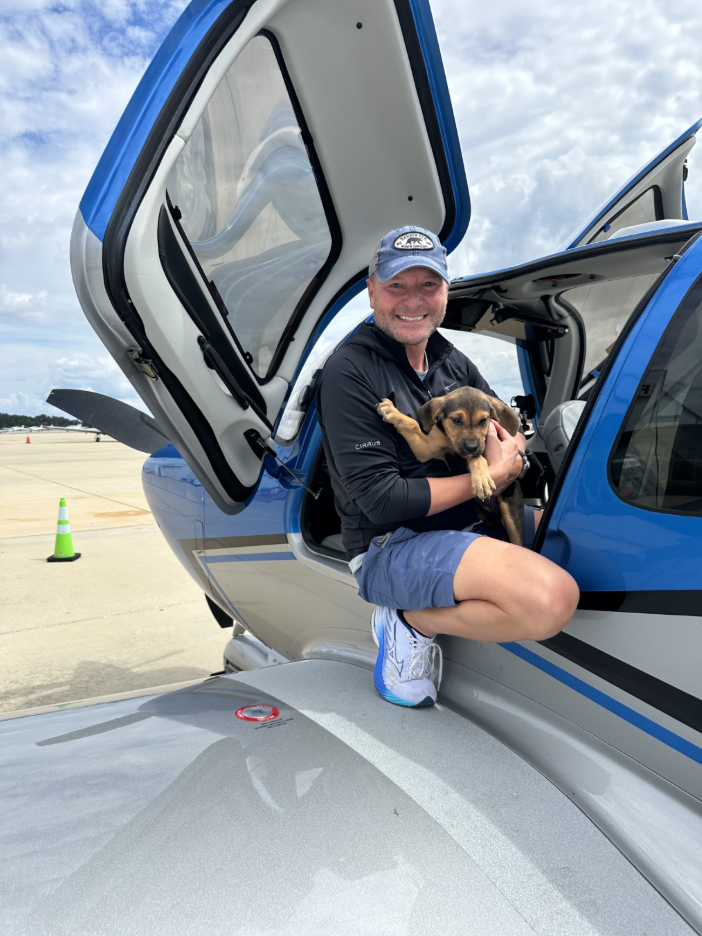 man and puppy boarding SR Series aircraft