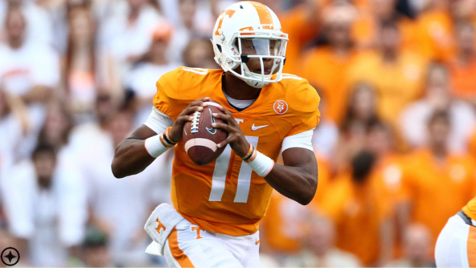 Josh Dobbs in a Tennessee Volunteers uniform preparing to throw a pass during a college football game