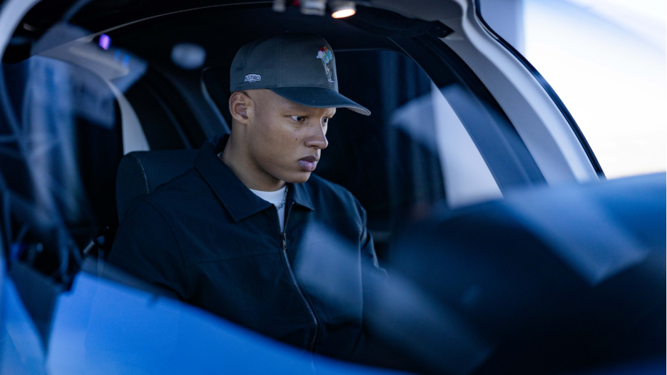 Josh Dobbs wearing a cap and headset, focused in the cockpit during flight training
