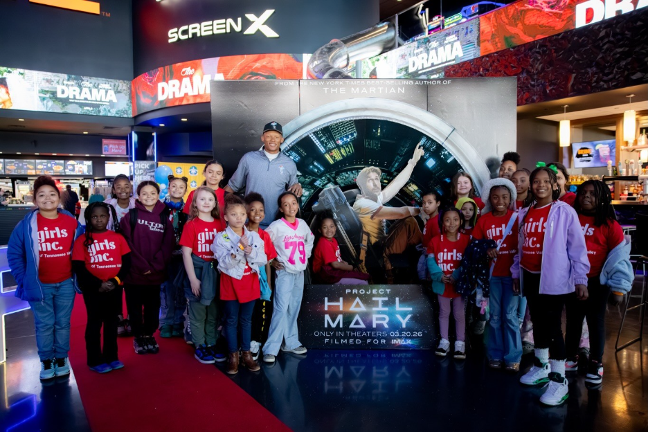 Josh Dobbs posing with children from Girls Inc. at a STEM outreach event through his Astrordinary Dobbs Foundation