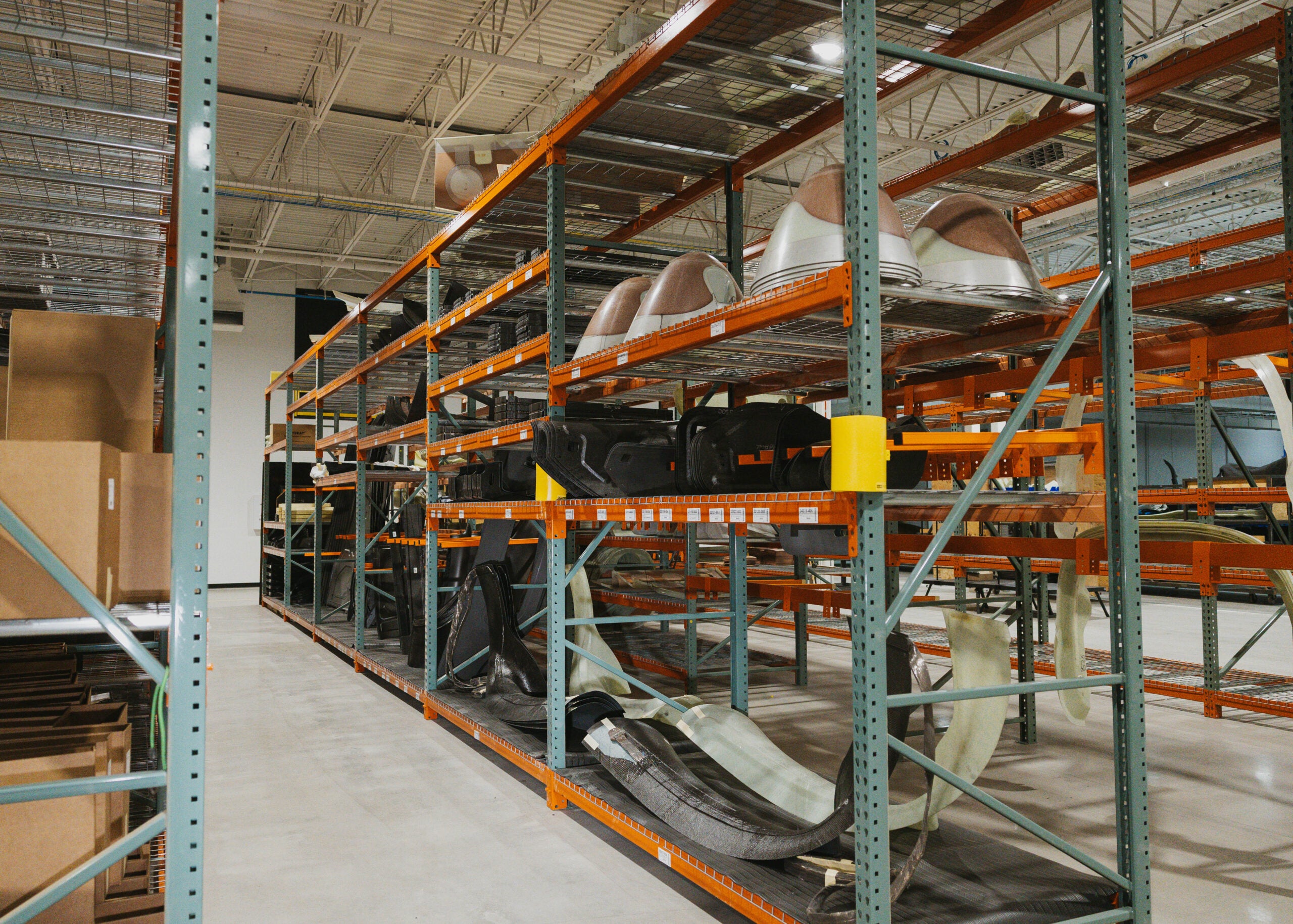 Composite aircraft components stored on warehouse racks at the Cirrus Grand Forks facility