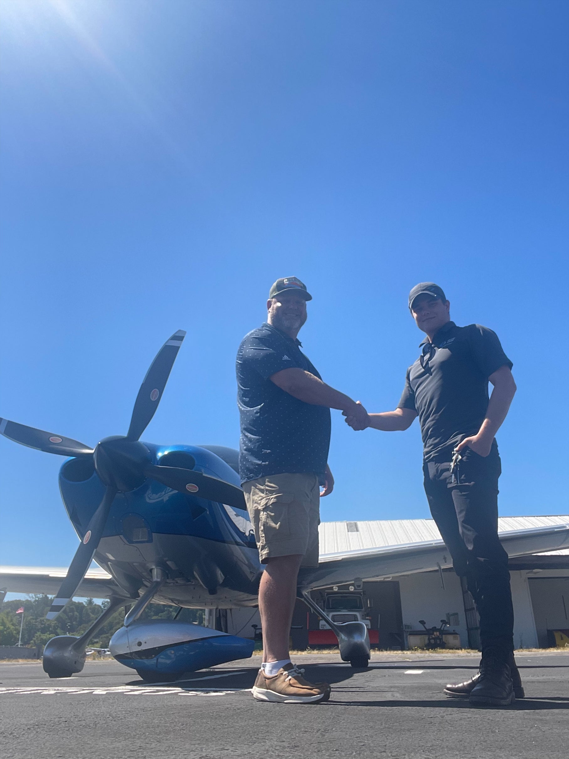 John Hutching celebrates a milestone in front of his SR Series aircraft.