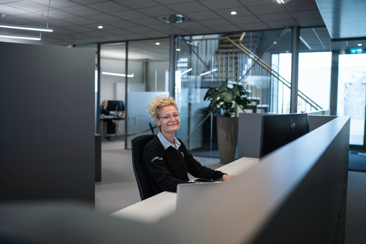 Cirrus Netherlands team member at the reception desk in the office